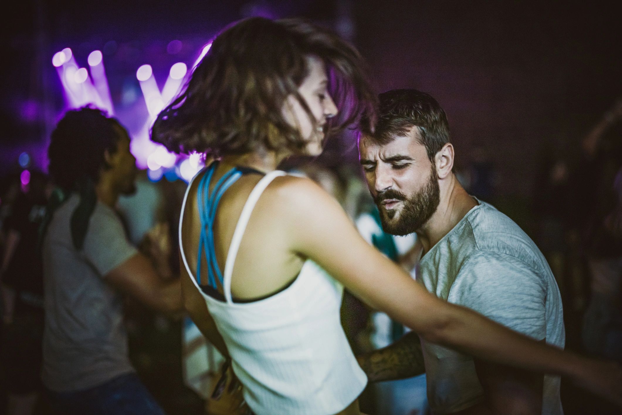 Couple dancing at a nighttime concert