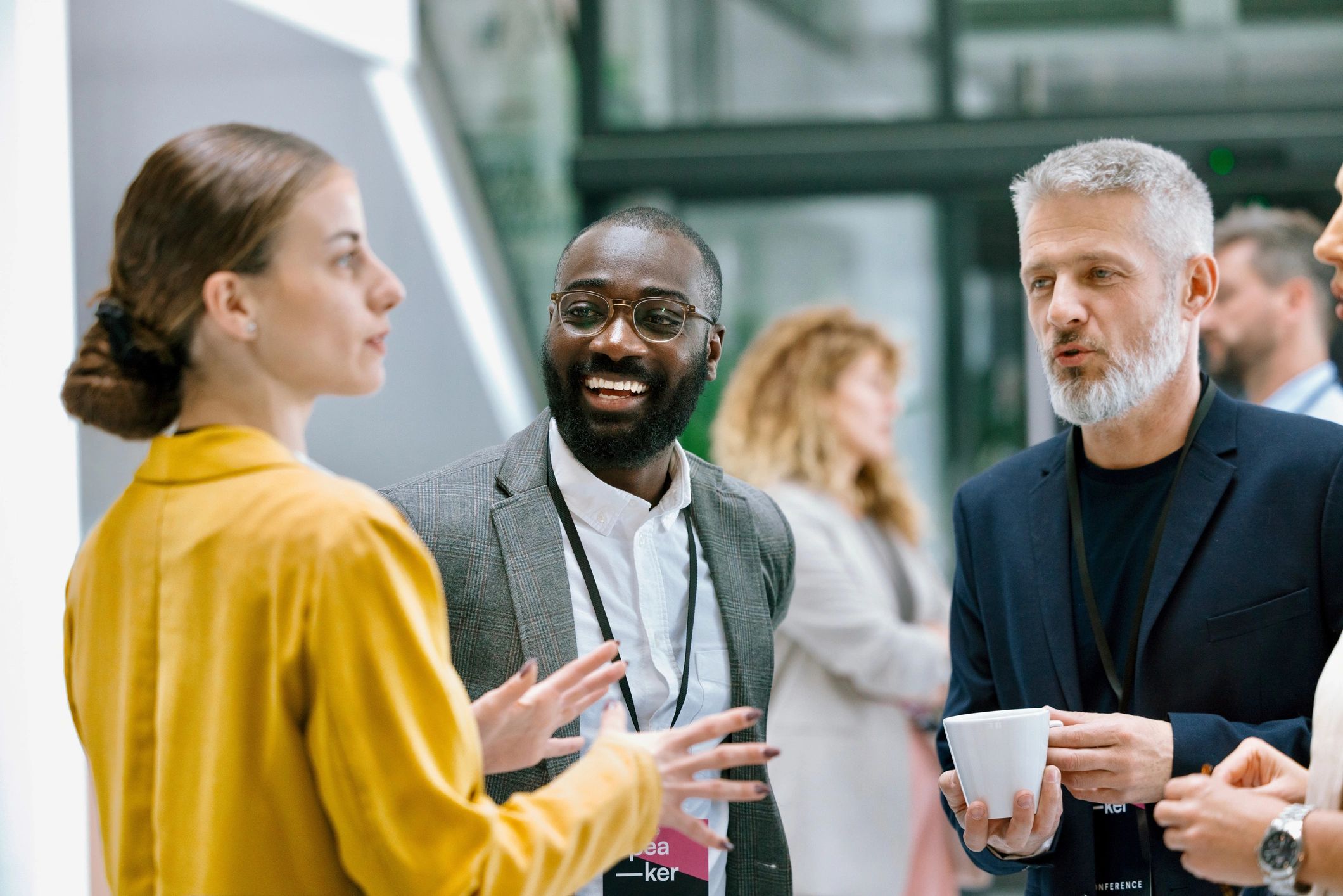 Colleagues chatting during a conference intermission
