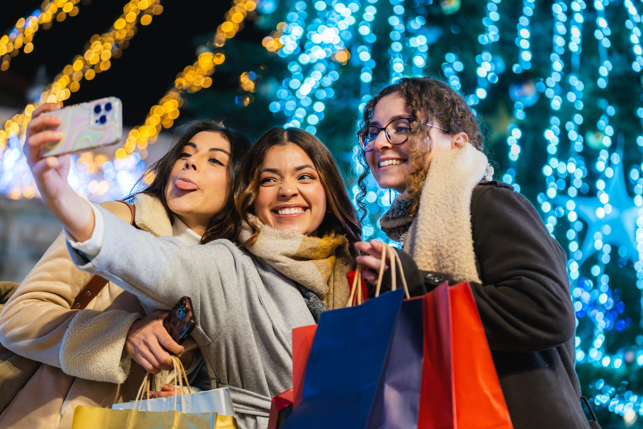 Friends taking a selfie at a festive night market