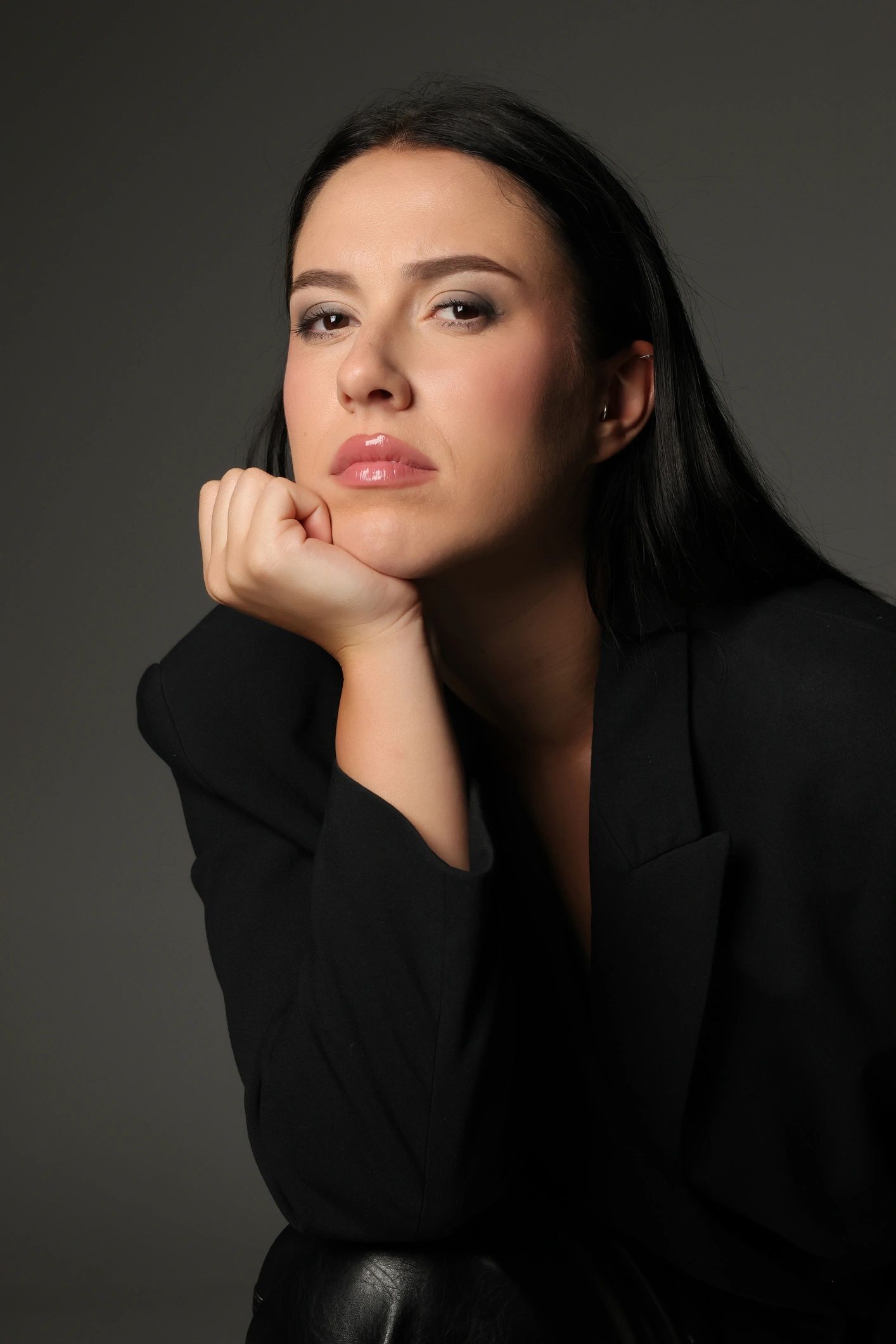 Studio close-up portrait against a dark background