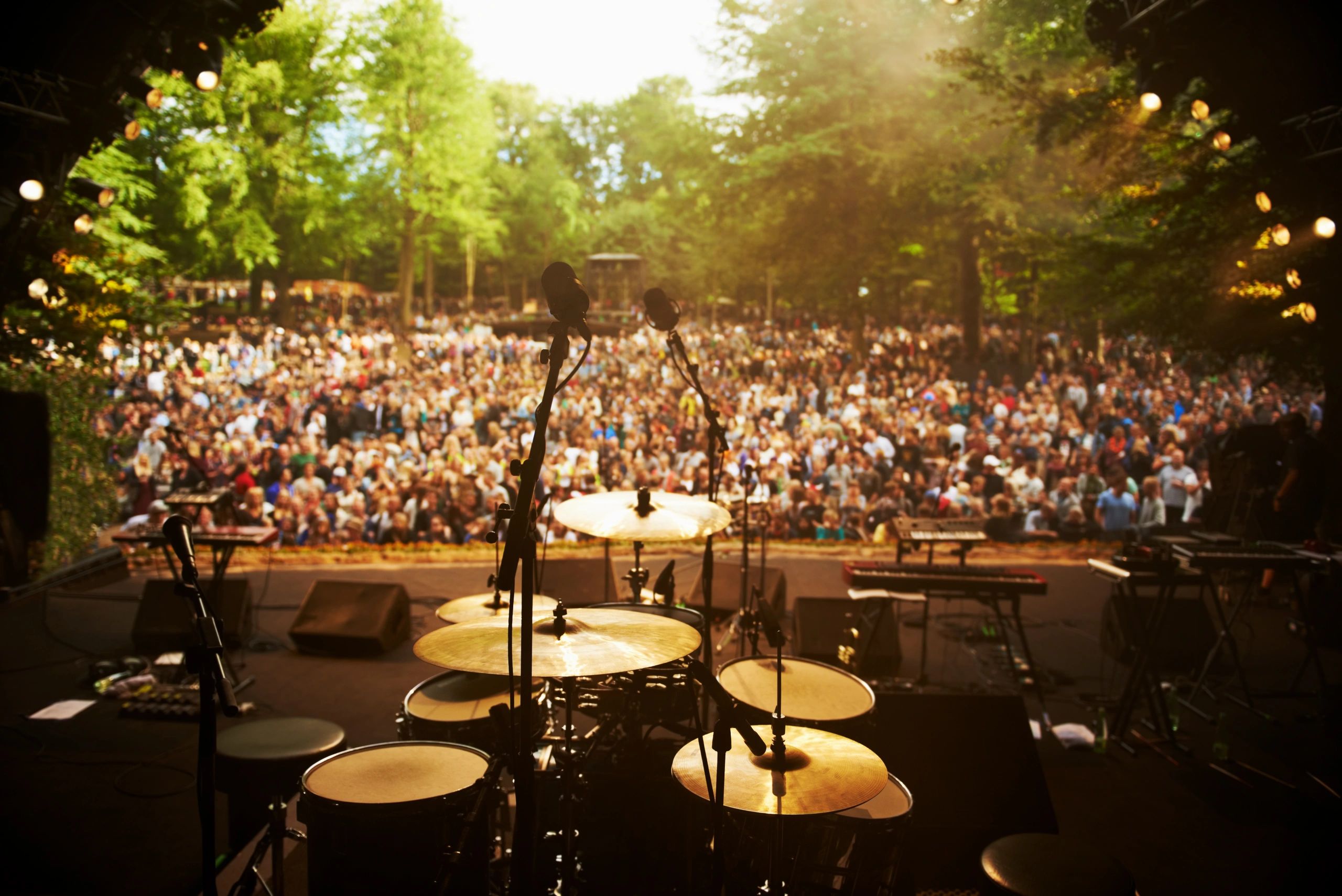 Stage view looking out over a large crowd at an event
