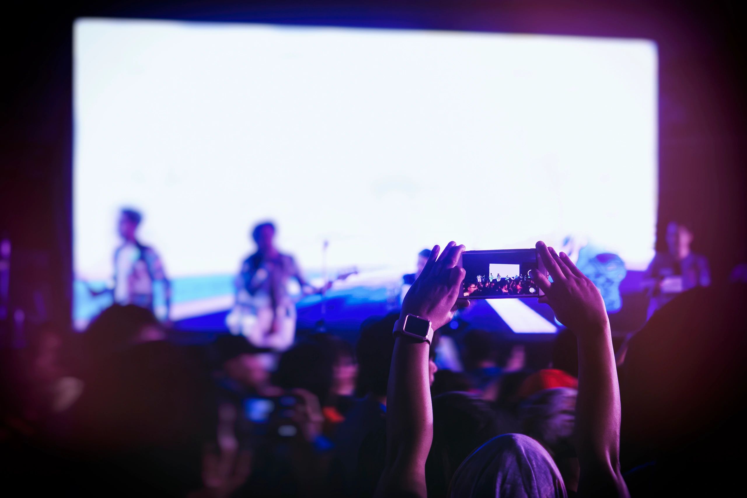 Phone capturing a concert crowd